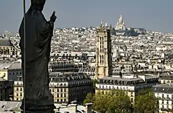 Οι τουρίστες εντυπωσιασμένοι, όπως τα μητροπολιτικά αγάλματα της Notre-Dame, πετούν πάνω από το Παρίσι