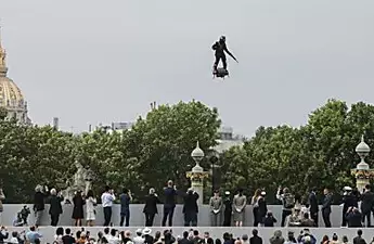 Γάλλος εφευρέτης ανεβαίνει πάνω από τα Champs-Élysées στην flyboard στην παρέλαση των Παρισίων