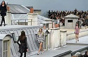 Woman gatecrashes Chanel Paris catwalk