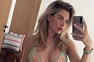 Megan Barton-Hanson shows off her pert bottom in a colourful bikini