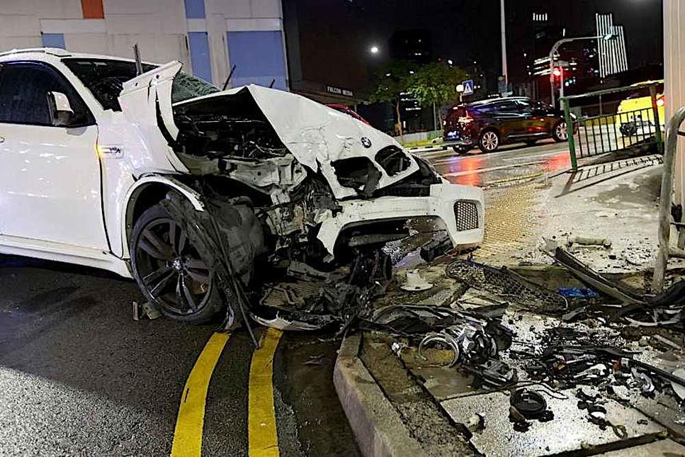 Four people taken to hospital after car hits man, crashes into building