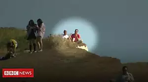Tourists sit at cliff edge after collapse