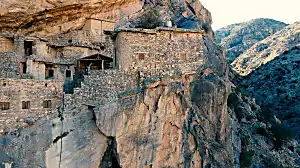 A village suspended on the side of a cliff