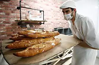 Armfuls of baguettes: French adapt bread buying habits to coronavirus lockdown