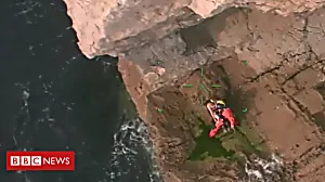Swimmer rescued by helicopter from rocks