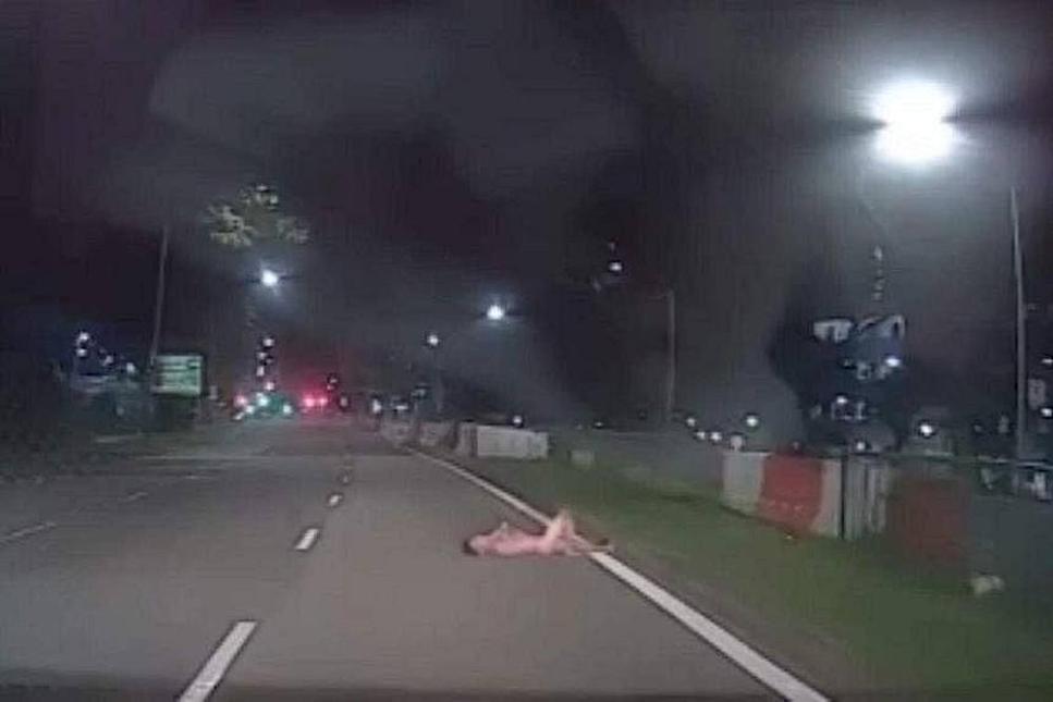 Man arrested after video shows him naked, lying on road in Sembawang