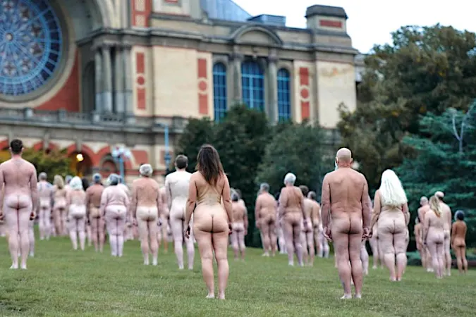 Hundreds pose nude wearing only masks for London art installation