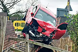 Passenger's inventive escape from car left dangling off bridge over canal