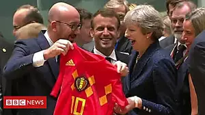 Theresa May receives a Belgium football shirt