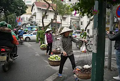 Tanks roll in, hotels fill up as thousands descend on Hanoi