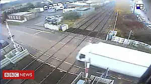 Lorry smashes through level crossing barrier