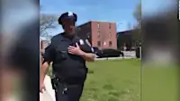 Baltimore police launch investigation into video that appears to show an officer repeatedly coughing on residents