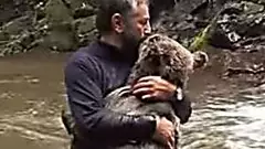 [Pics] Mama Bear Hugs Man After He Saves Her Drowning Cub