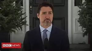Trudeau grabs coat during live press briefing