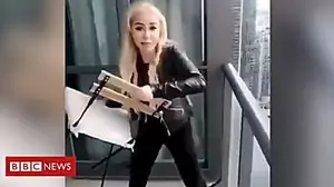 Woman throws chair from high-rise balcony