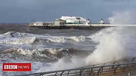 Woman swept into sea by huge wave