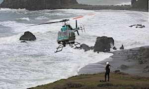 A father dies and his two young children are missing after they were swept away by a wave