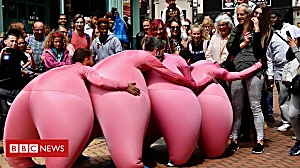 Giant pink dancers draw in crowds