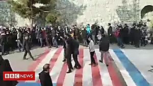 Students refuse to walk over US and Israeli flags