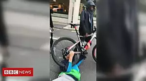 Cyclist dragged across road in mugging