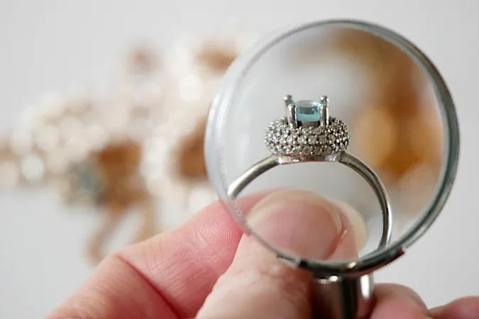 A woman is selling her ex-boyfriend's ring. The jeweler tells her this.